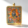 Hand-painted Mahakala miniature thangka pendant in a gold frame, studio shot