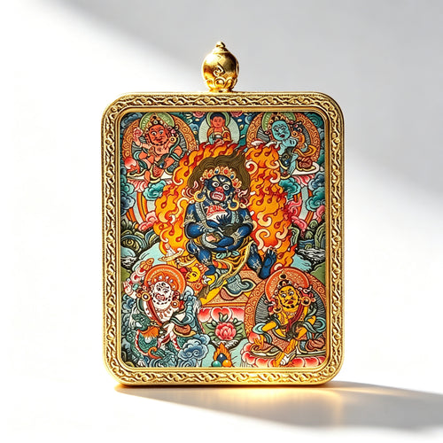 Hand-painted Mahakala miniature thangka pendant in a gold frame, studio shot